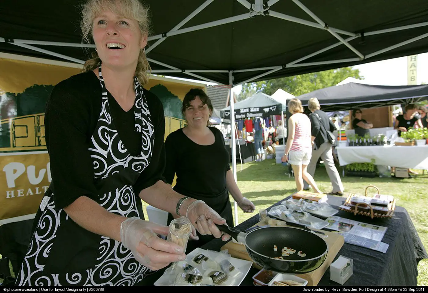 a woman cooking at a market