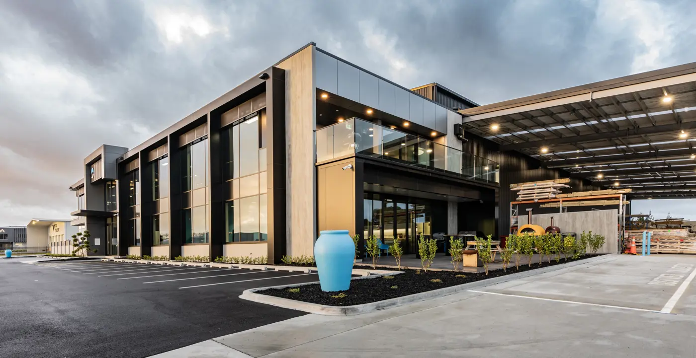 a building with glass walls and a large blue vase