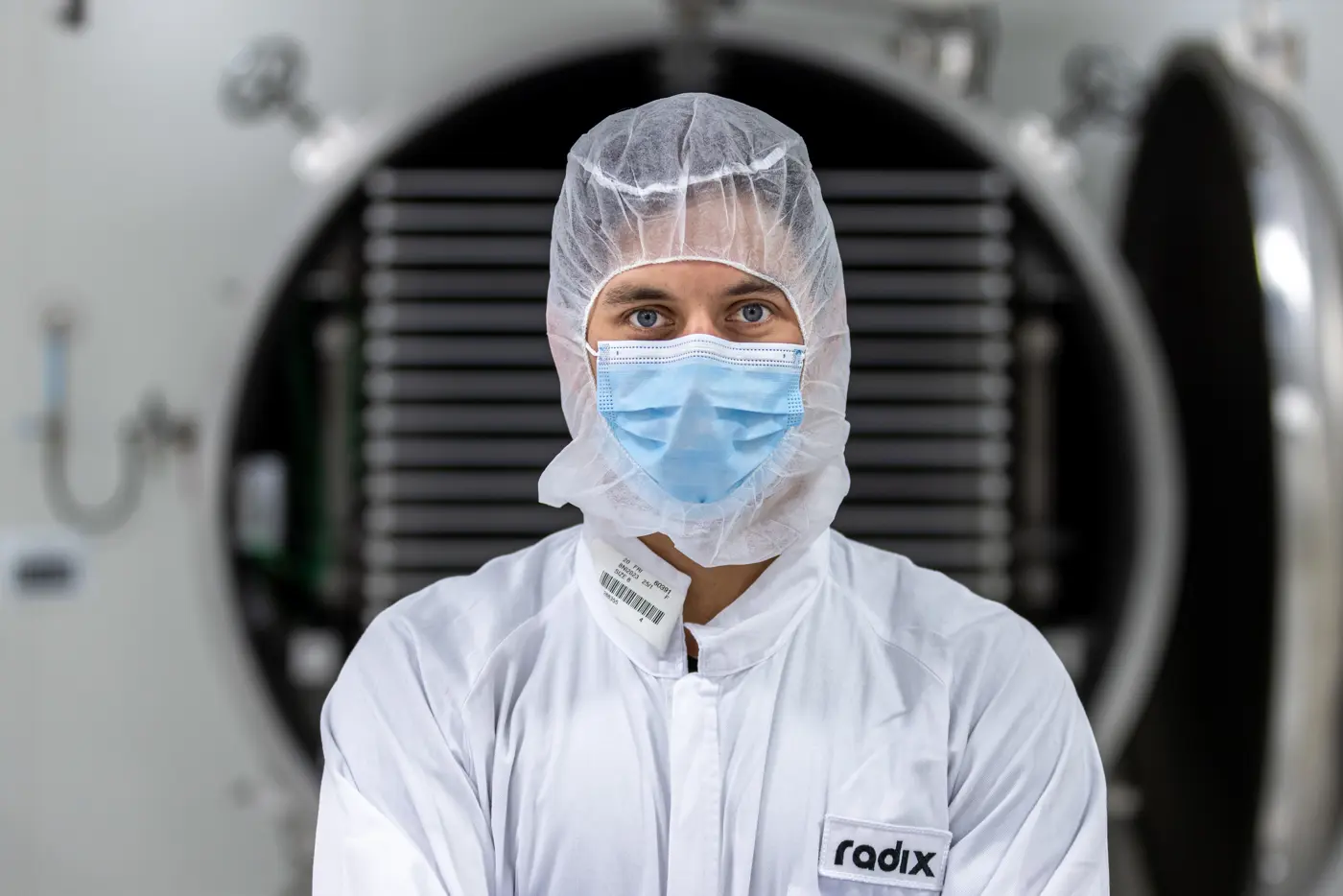 a man in a white suit and mask