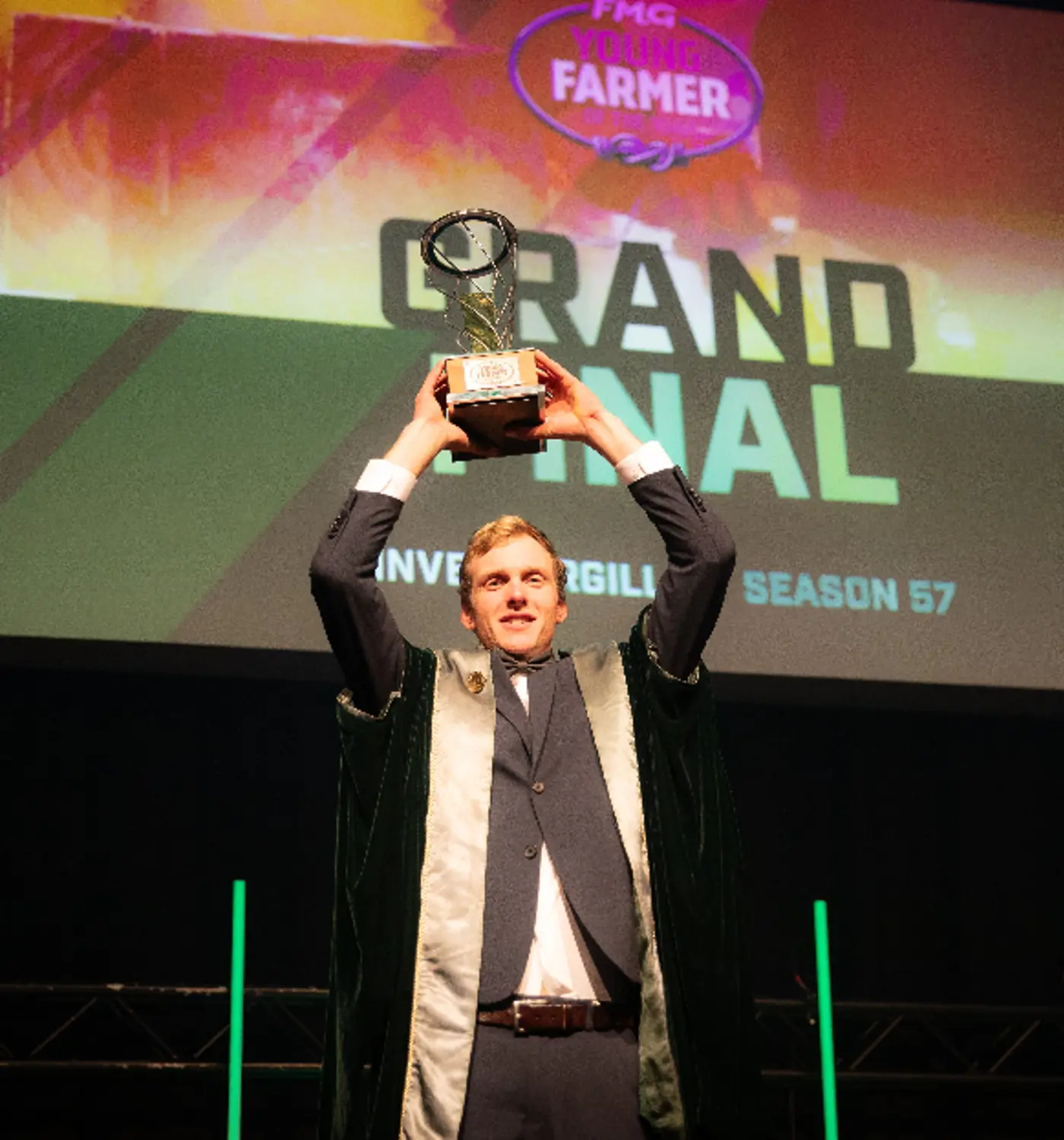 a man holding up a trophy