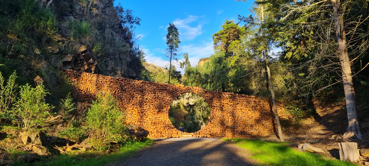 a stone wall with a circular arch