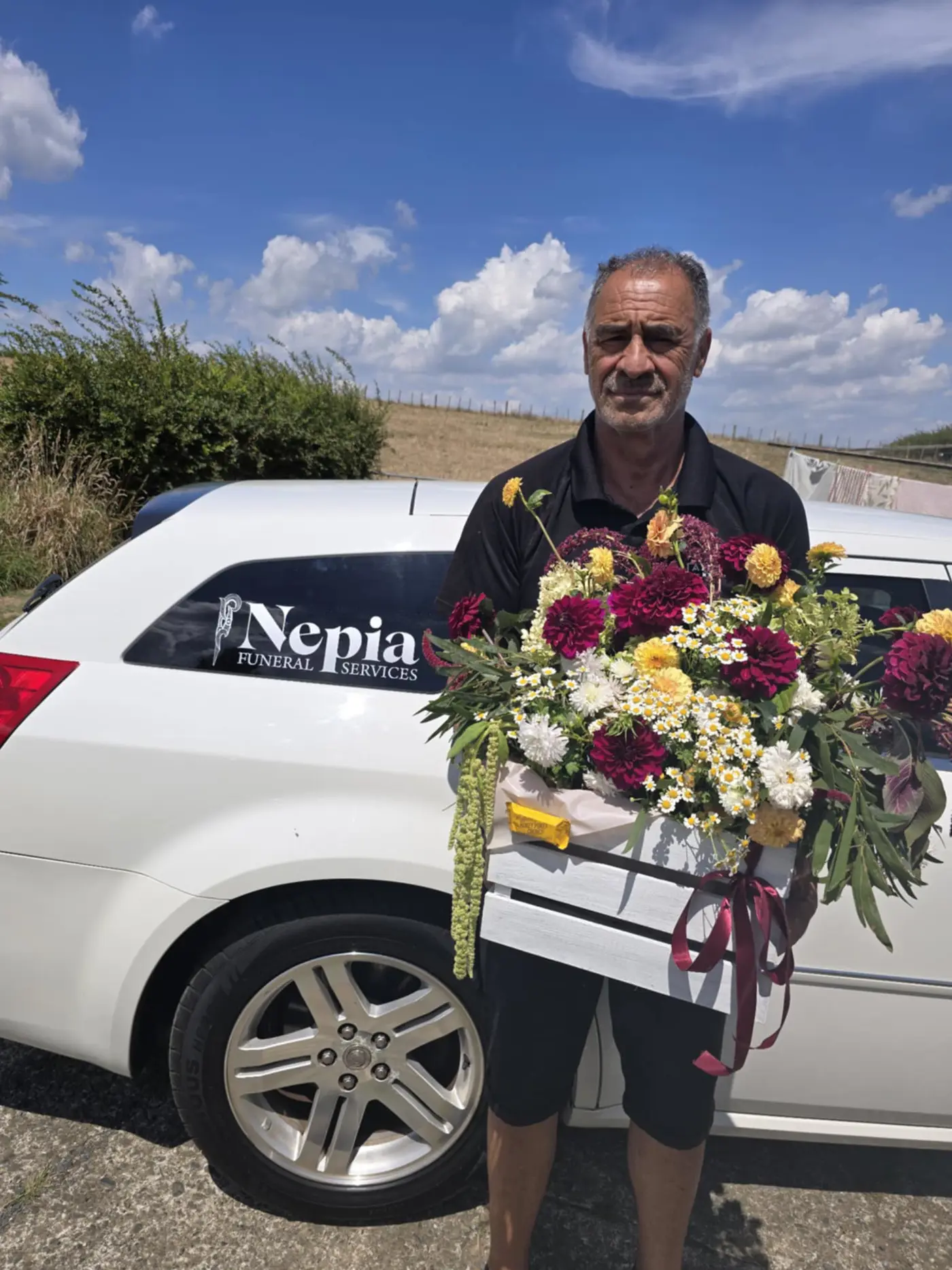 a man holding a box of flowers