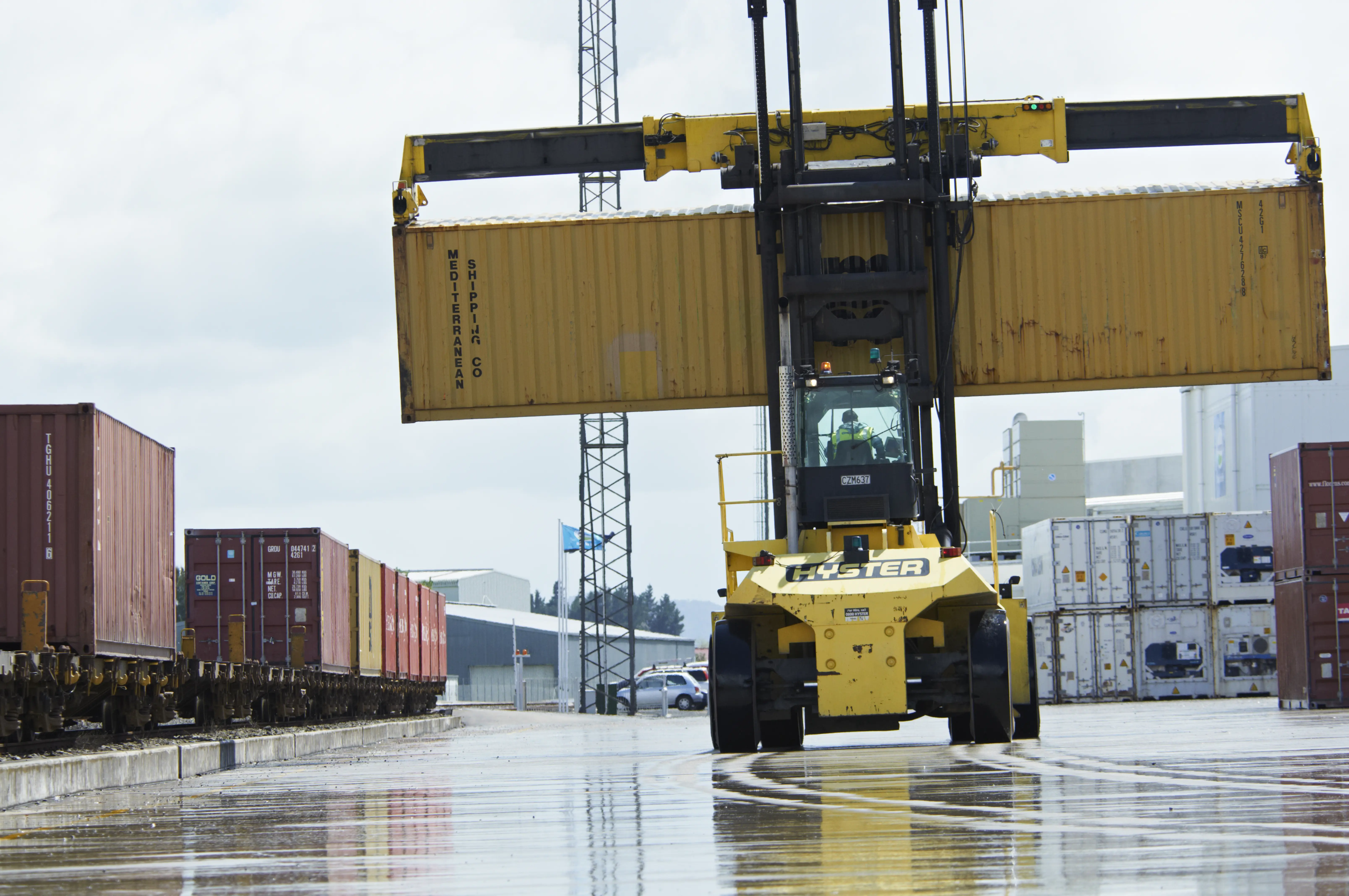 a forklift lifting a container