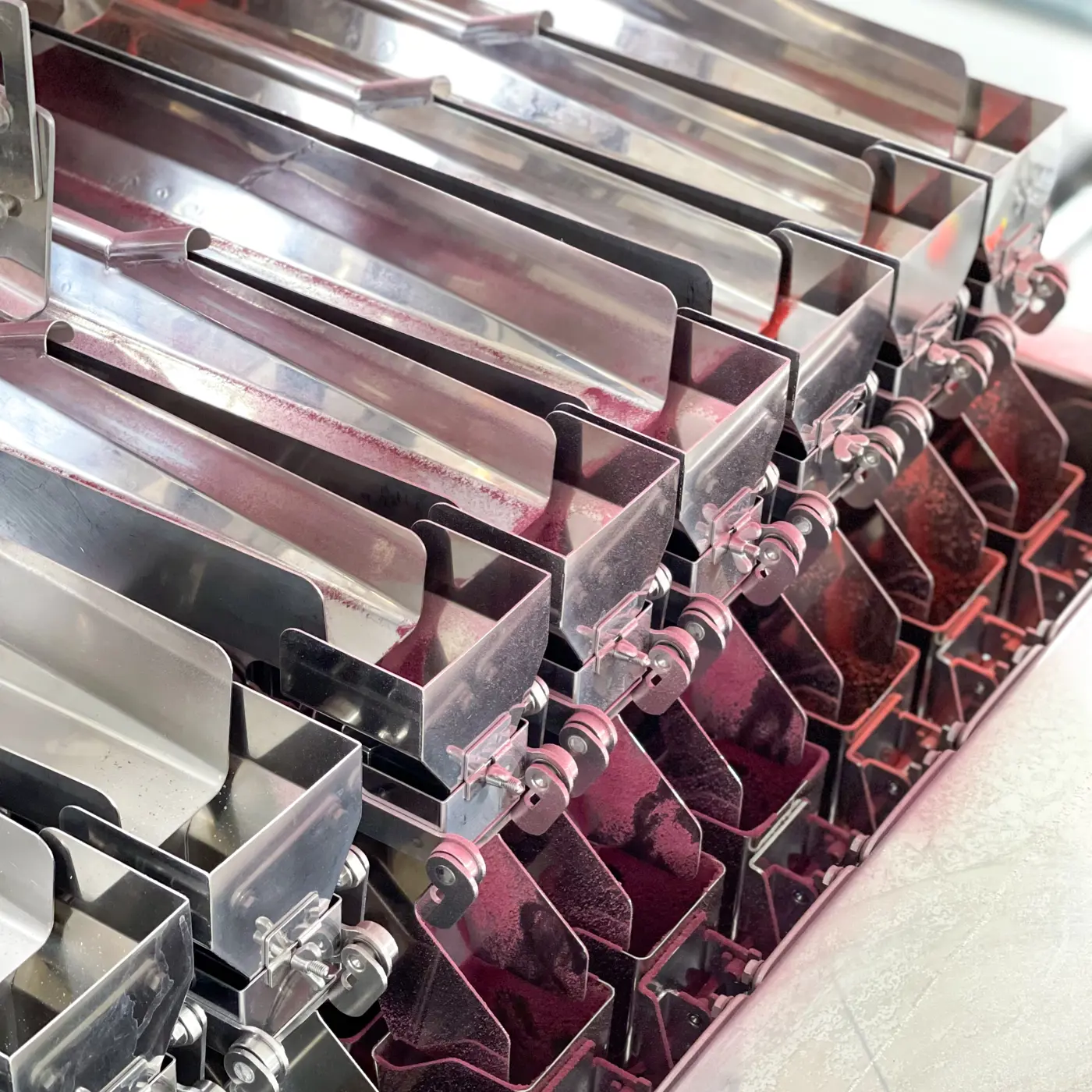 a group of metal objects with red liquid inside