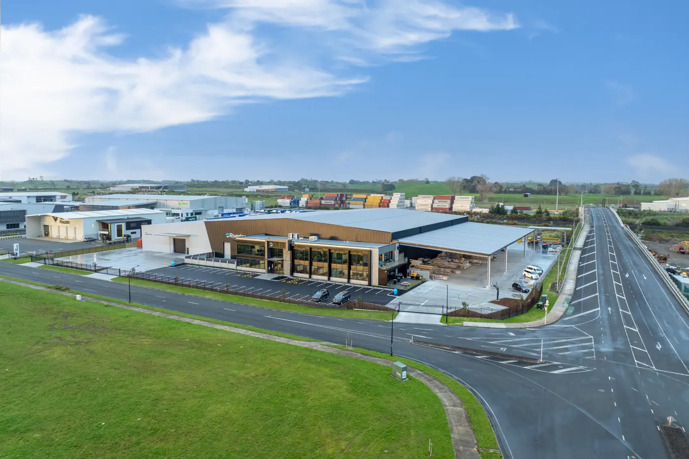 a building with a parking lot and a road