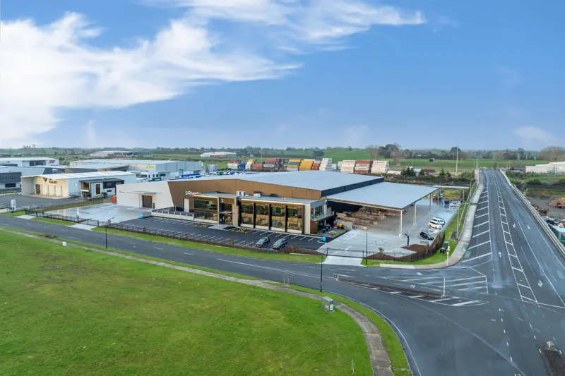 a building with a parking lot and a road