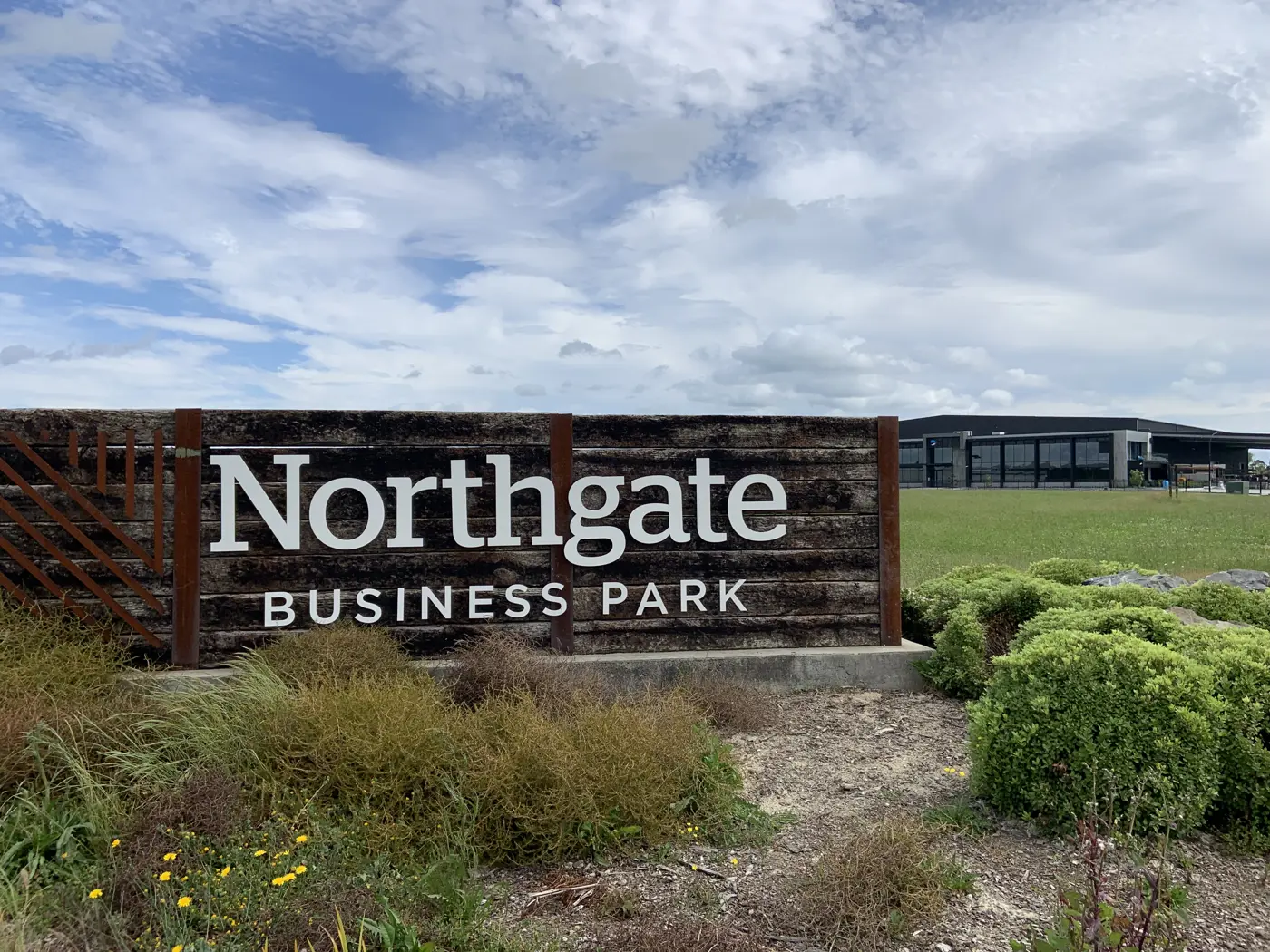 a sign in front of a field