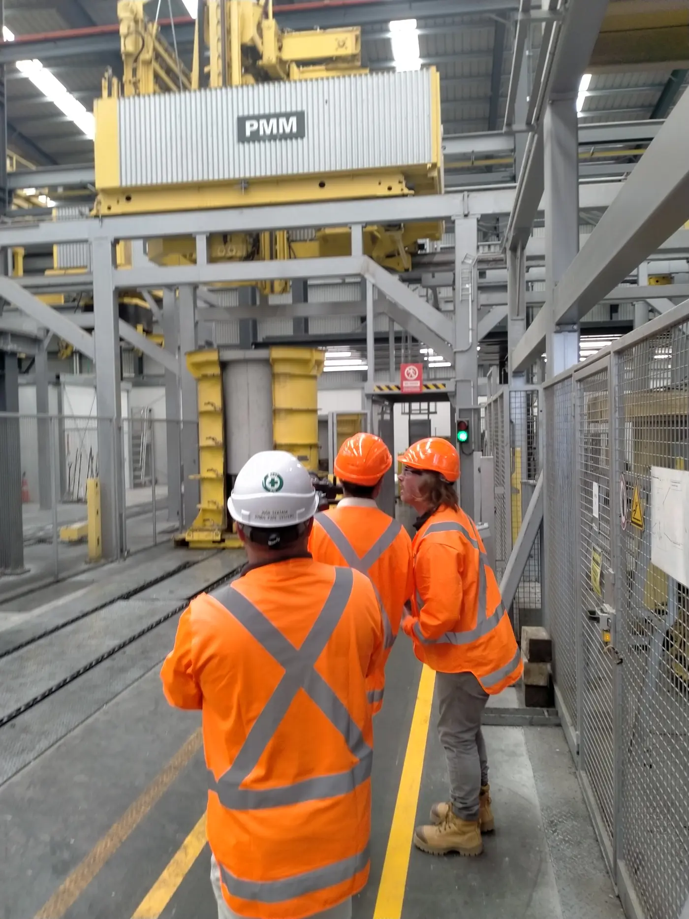 a group of men in orange vests and helmets