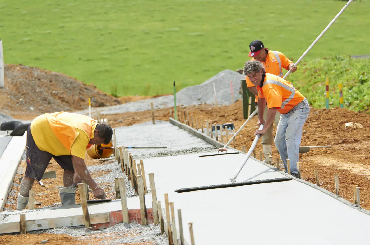 a group of men working on a concrete slab