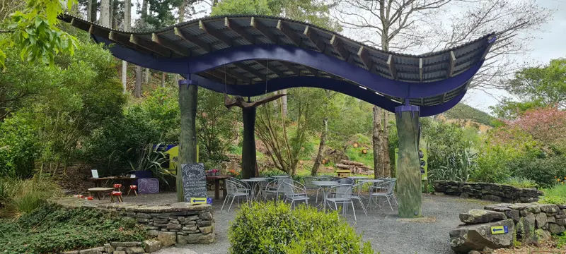 a covered area with tables and chairs