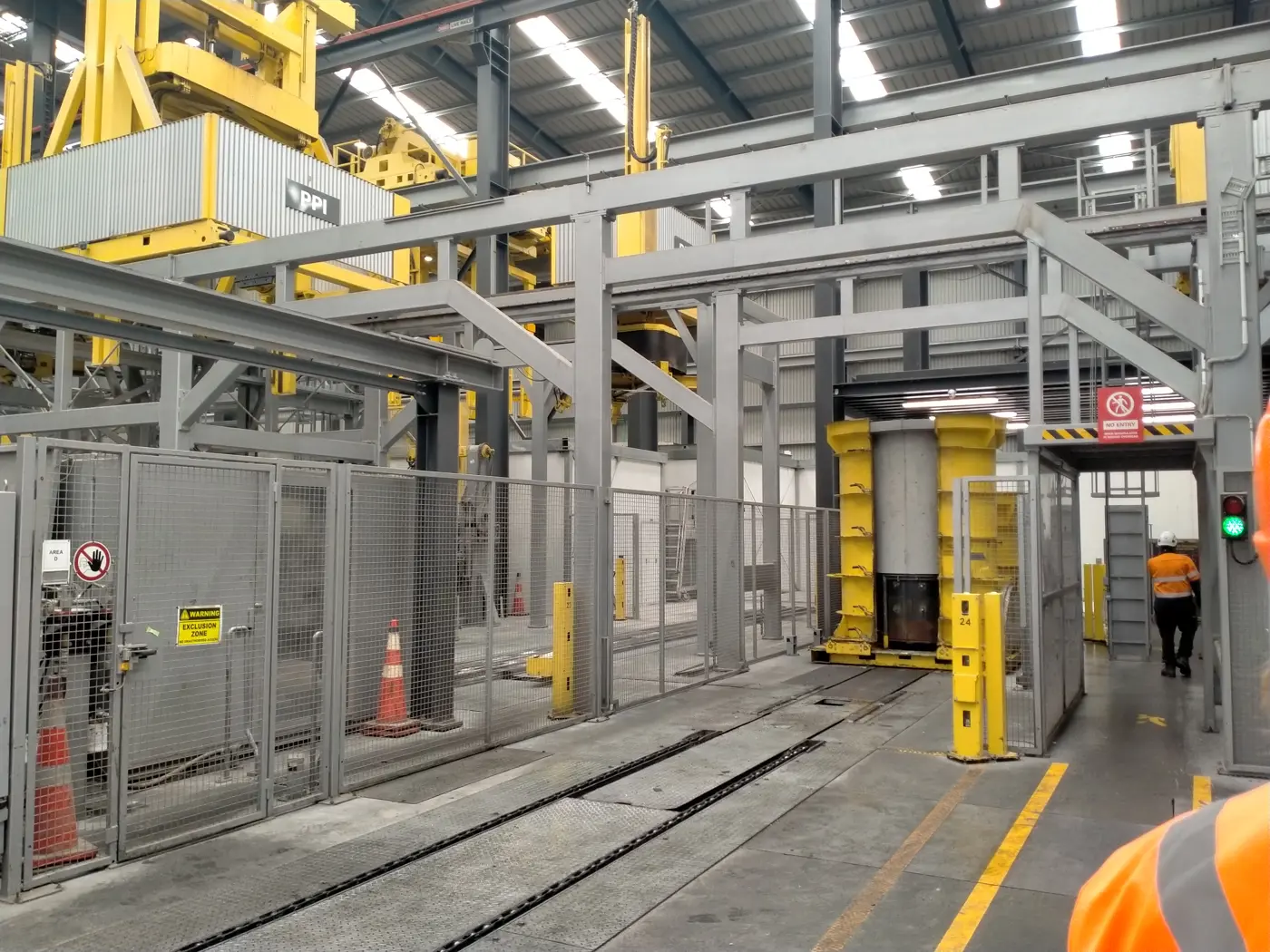 a metal structure with yellow and gray objects