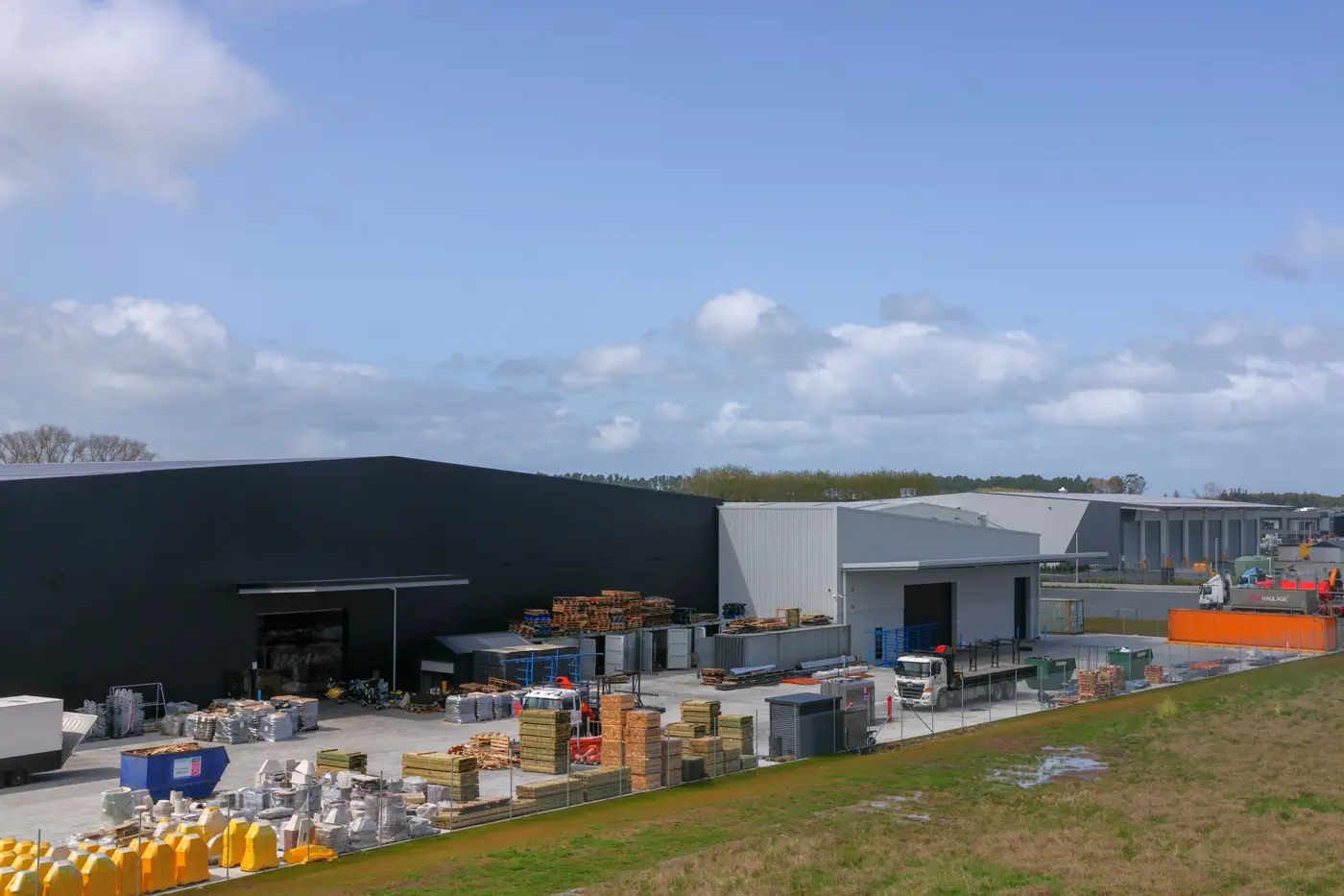 a warehouse with pallets and pallets in front of it