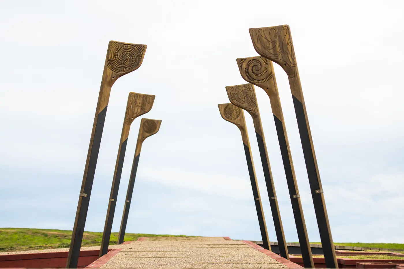 a group of wooden paddles on a walkway