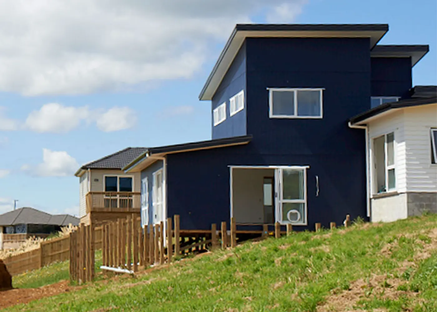a blue house on a hill