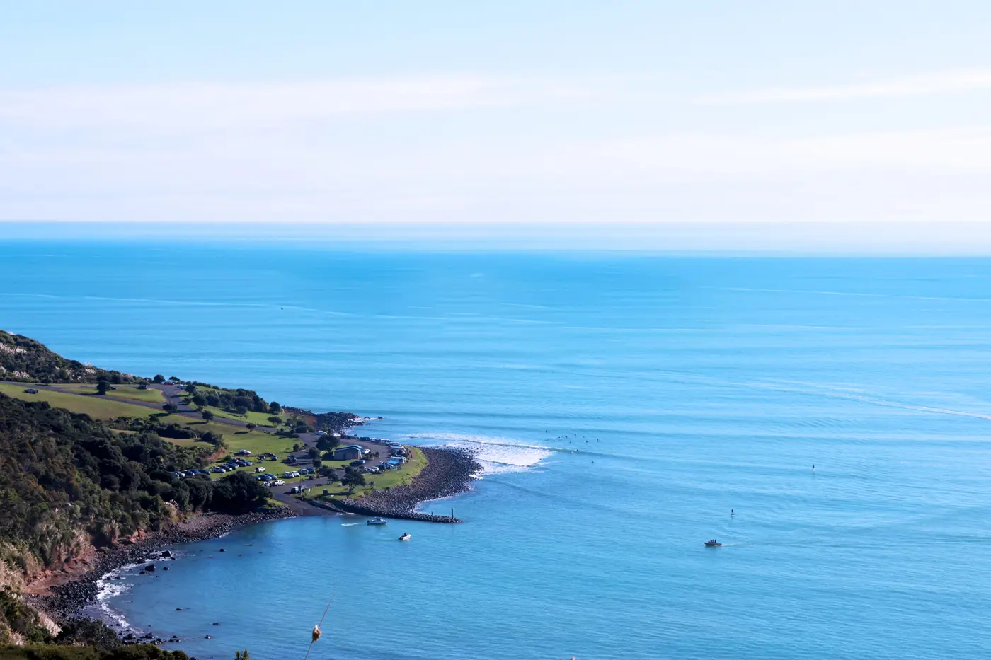 a body of water with a beach and land and trees