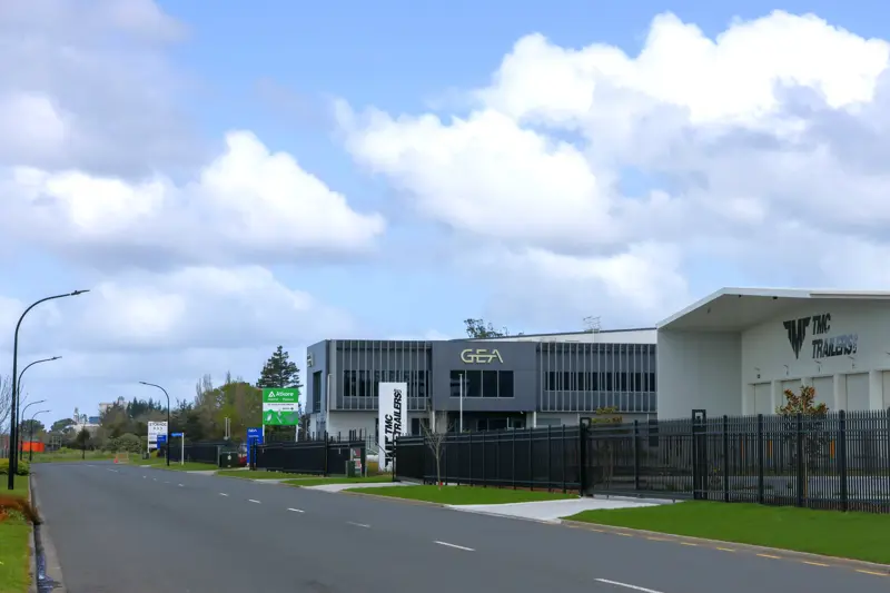 a building with a fence and grass