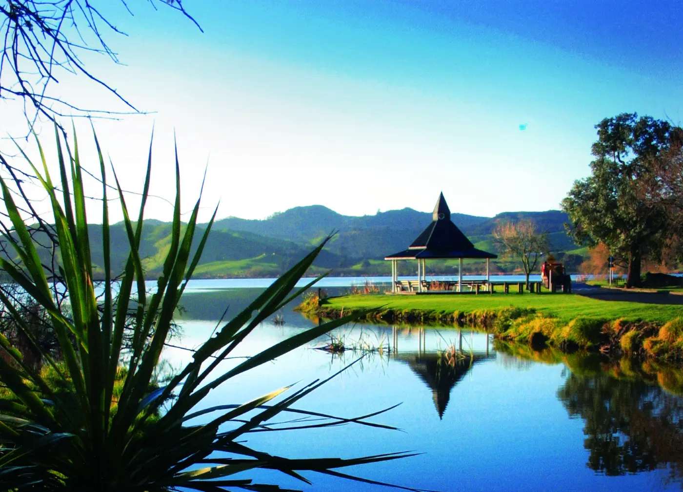 a gazebo on the edge of a lake