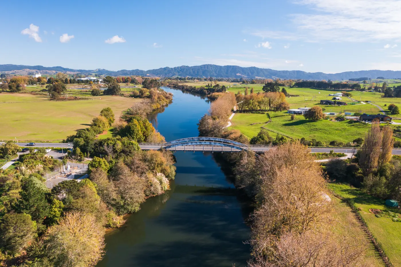 a river with a bridge over it