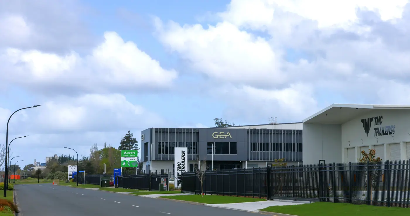 a building with a fence and grass