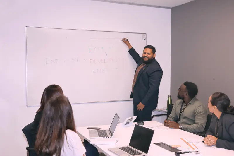 a man writing on a whiteboard