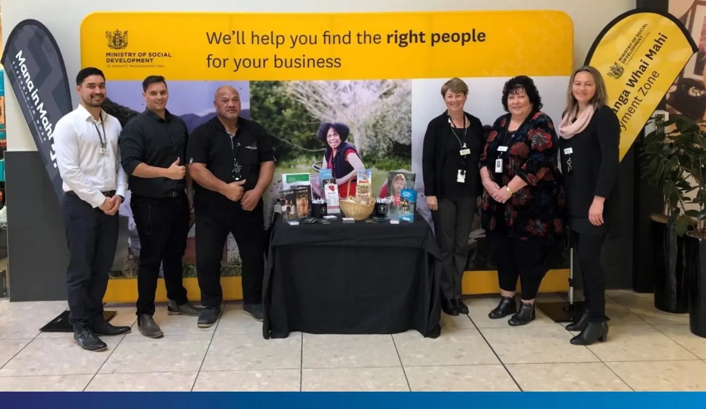 a group of people standing in front of a sign