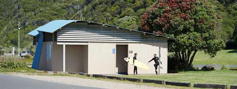 a group of people holding surfboards