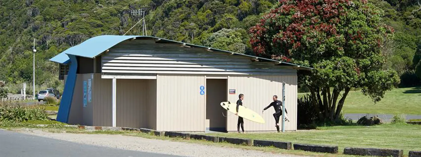 a group of people holding surfboards