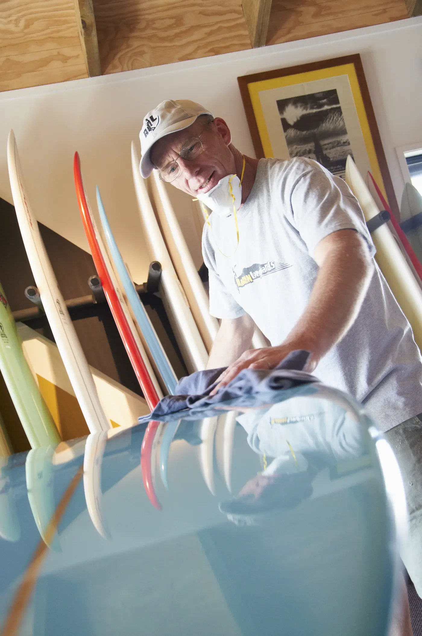 a man cleaning a surfboard