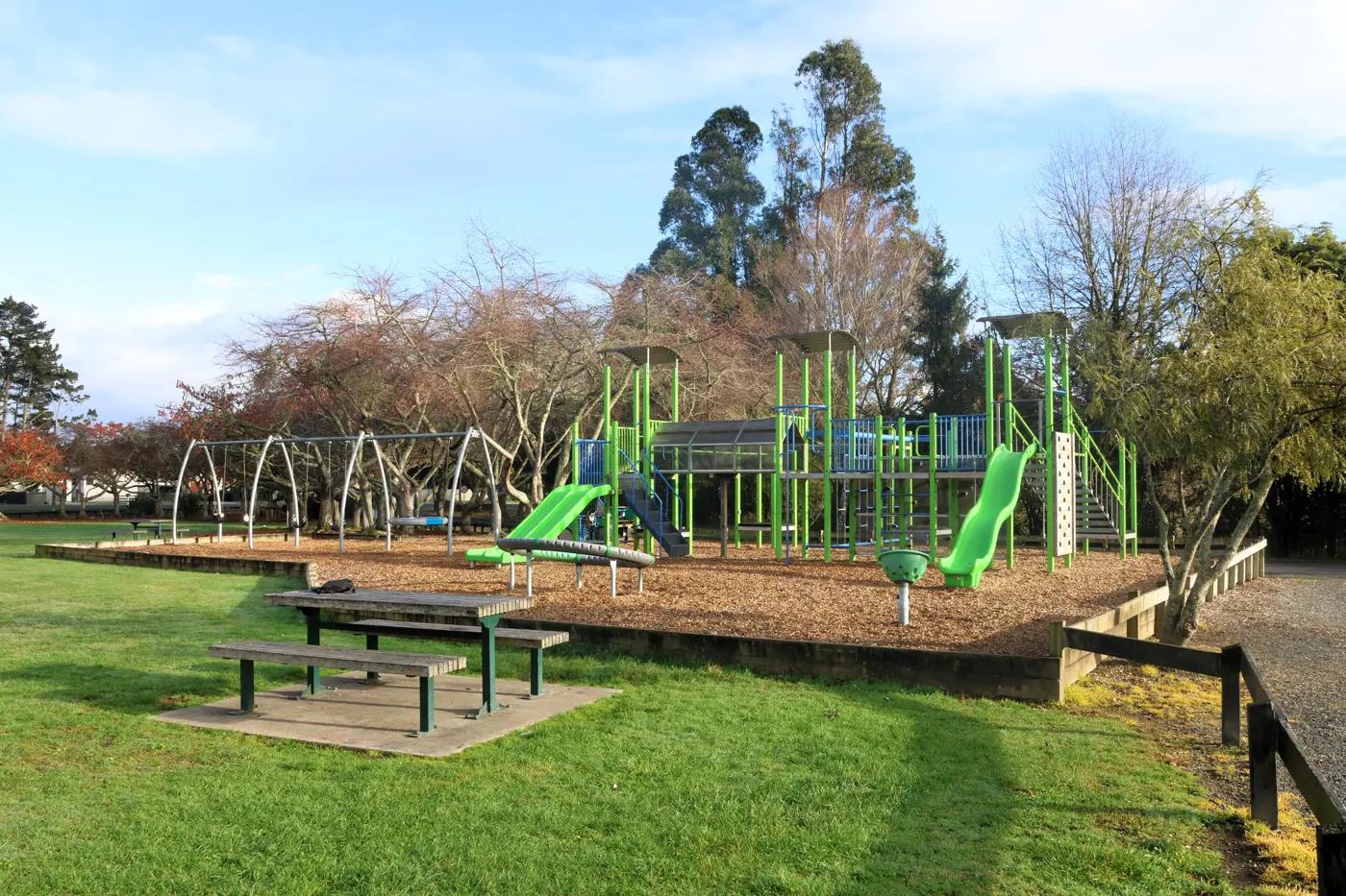 a playground with a bench and a bench