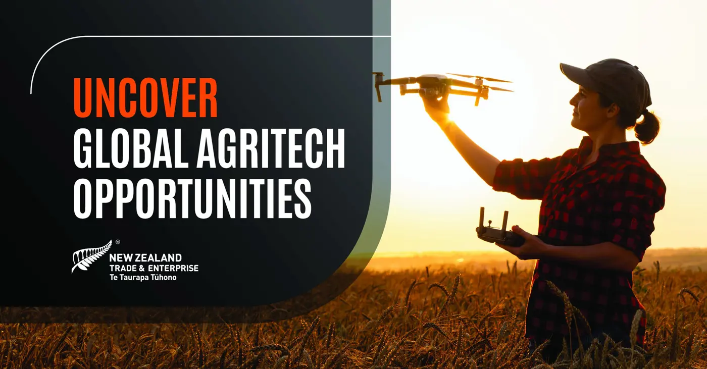 a man holding a drone in a field