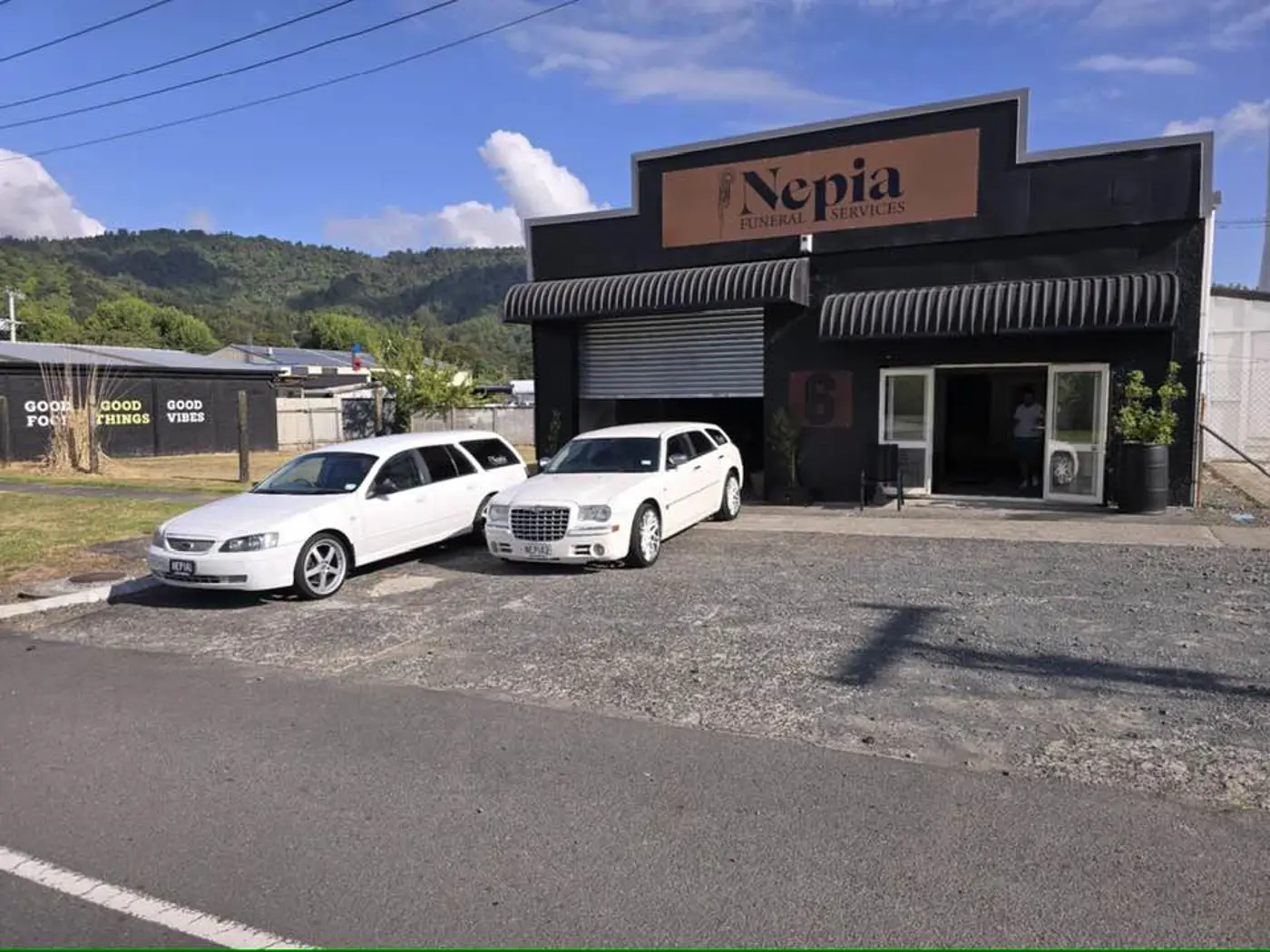 a white cars parked in front of a building