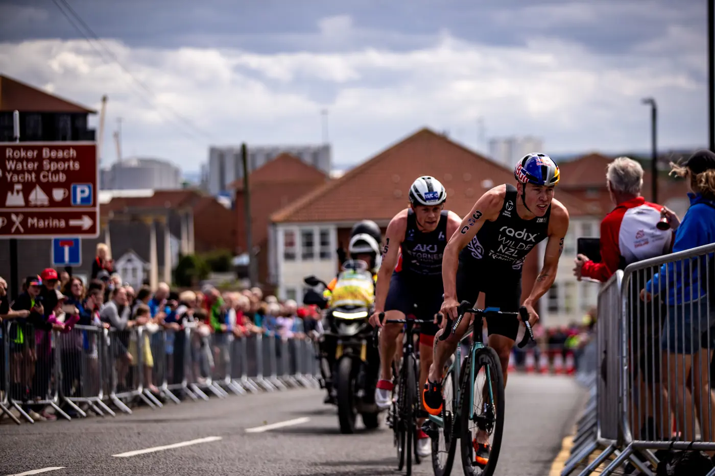 a group of people riding bicycles on a road